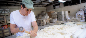 Worker at a Limestone Company Chiseling a Sculpture