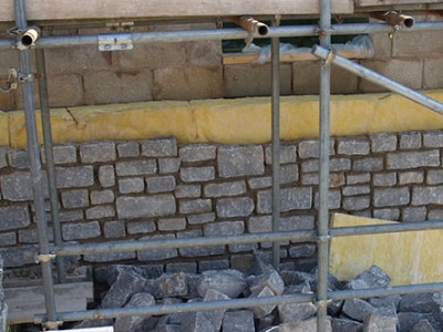 Limestone Being Used To Build Wall For House
