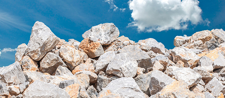 Bunch of rocks of limestone with a blue sky behind it