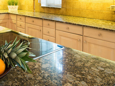 Marble countertops with fruit basket on it