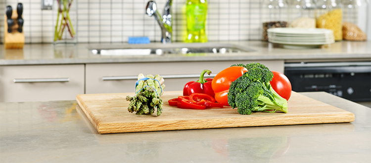 cutting-board-with-veggies-on-limestone-counter